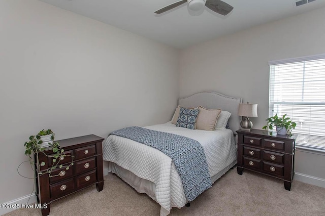 873 Bourne Dr SW, Ocean Isle Beach, NC 28469 - bedroom with multiple windows, light carpet, baseboards, and ceiling fan