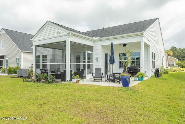 873 Bourne Dr SW, Ocean Isle Beach, NC 28469 - back of property with a ceiling fan, a patio area, a yard, and a sunroom