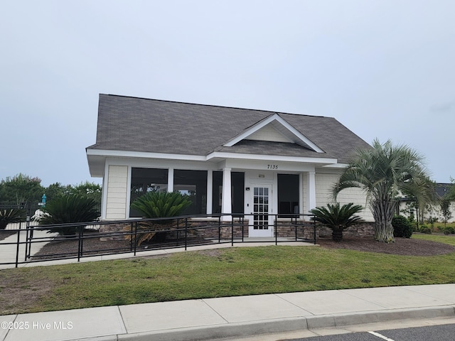 873 Bourne Dr SW, Ocean Isle Beach, NC 28469 - view of front of home with a front lawn and roof with shingles
