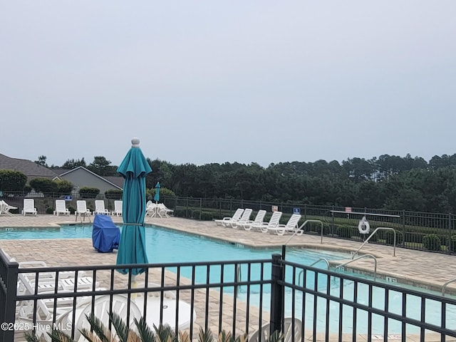 873 Bourne Dr SW, Ocean Isle Beach, NC 28469 - community pool featuring a patio and a forest view