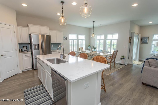 873 Bourne Dr SW, Ocean Isle Beach, NC 28469 - kitchen featuring stainless steel appliances, a sink, open floor plan, white cabinets, and recessed lighting