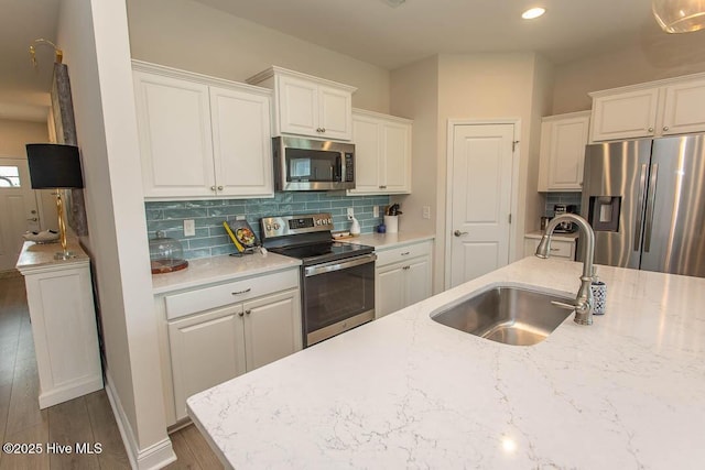 873 Bourne Dr SW, Ocean Isle Beach, NC 28469 - kitchen with appliances with stainless steel finishes, a sink, backsplash, white cabinets, and recessed lighting