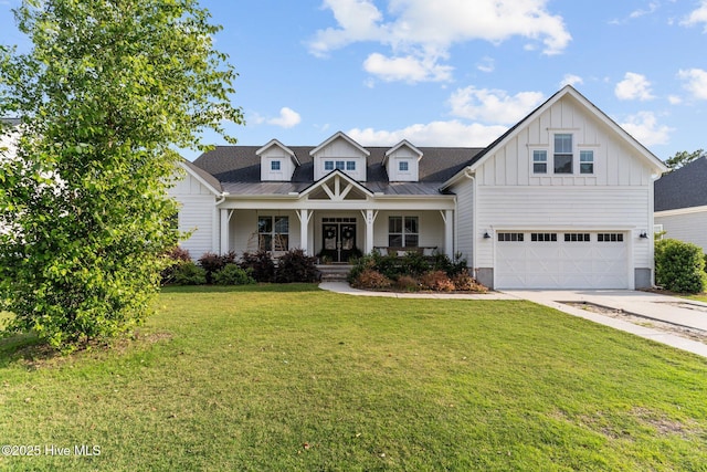 386 Yucca Ln, Wilmington, NC 28412 - view of front facade with board and batten siding, an attached garage, covered porch, a front yard, and concrete driveway