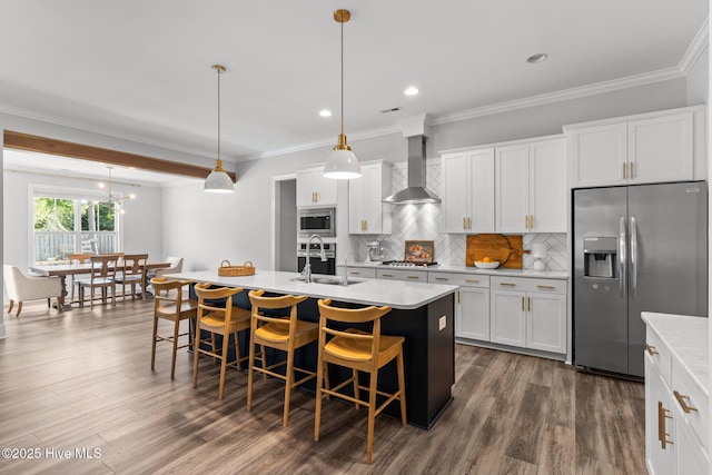 386 Yucca Ln, Wilmington, NC 28412 - kitchen with stainless steel appliances, a sink, wall chimney range hood, light countertops, and a kitchen island with sink