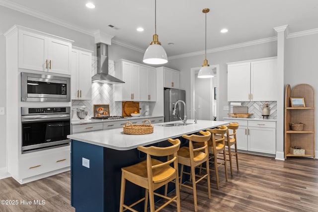 386 Yucca Ln, Wilmington, NC 28412 - kitchen featuring stainless steel appliances, wall chimney range hood, a sink, dark wood-style floors, and recessed lighting