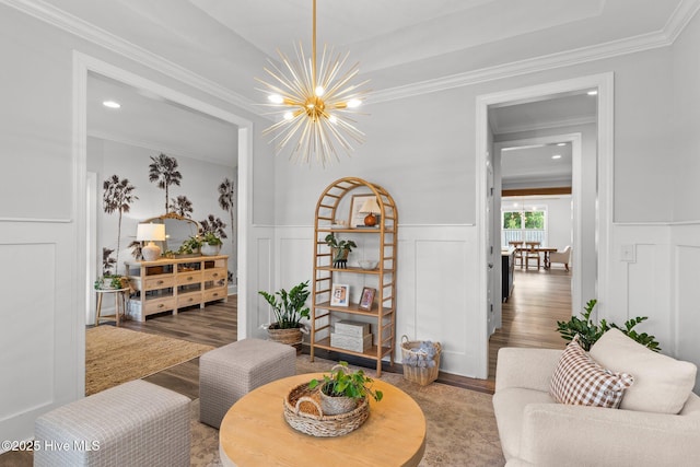 386 Yucca Ln, Wilmington, NC 28412 - living room featuring a decorative wall, a chandelier, wood finished floors, ornamental molding, and wainscoting
