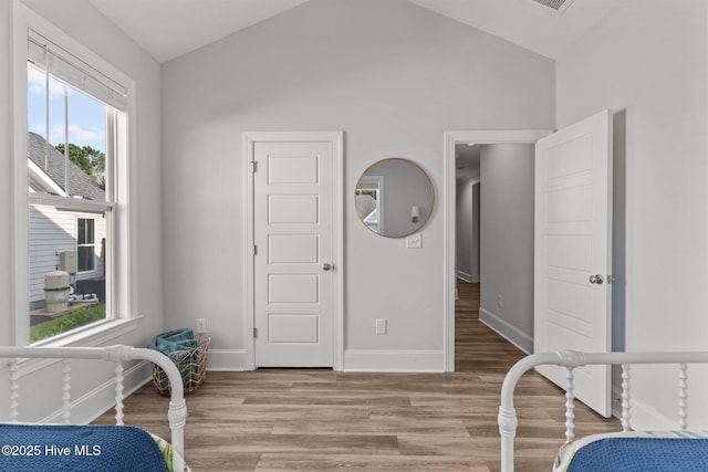 386 Yucca Ln, Wilmington, NC 28412 - bedroom with vaulted ceiling, light wood-type flooring, and baseboards