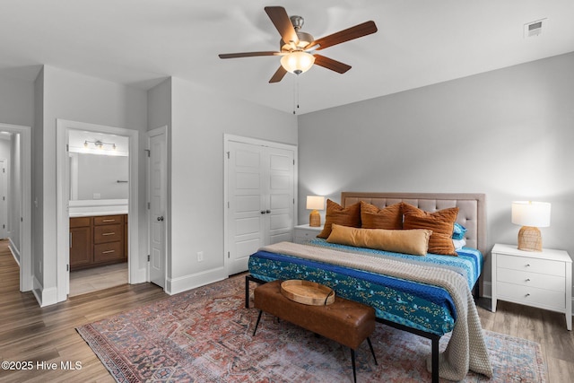 386 Yucca Ln, Wilmington, NC 28412 - bedroom with wood finished floors, baseboards, ensuite bath, a closet, and ceiling fan