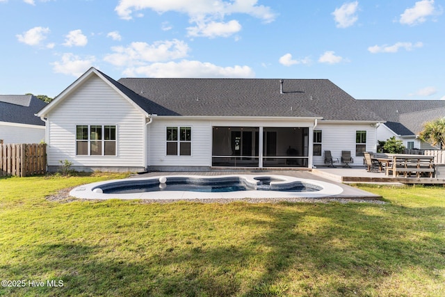 386 Yucca Ln, Wilmington, NC 28412 - rear view of house with a sunroom, a patio, a pool with connected hot tub, and a shingled roof