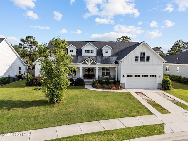 386 Yucca Ln, Wilmington, NC 28412 - modern inspired farmhouse featuring board and batten siding, a porch, a garage, driveway, and a front yard