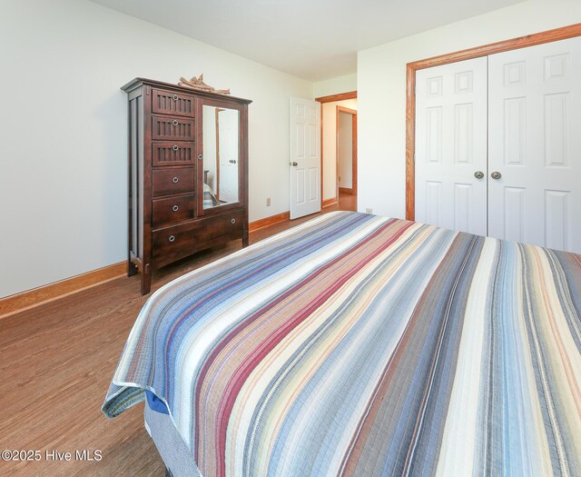 813 Puddin Ridge Rd, Moyock, NC 27958 - bedroom featuring baseboards, a closet, and wood finished floors