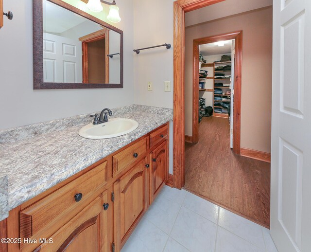 813 Puddin Ridge Rd, Moyock, NC 27958 - bathroom with vanity, wood finished floors, and baseboards