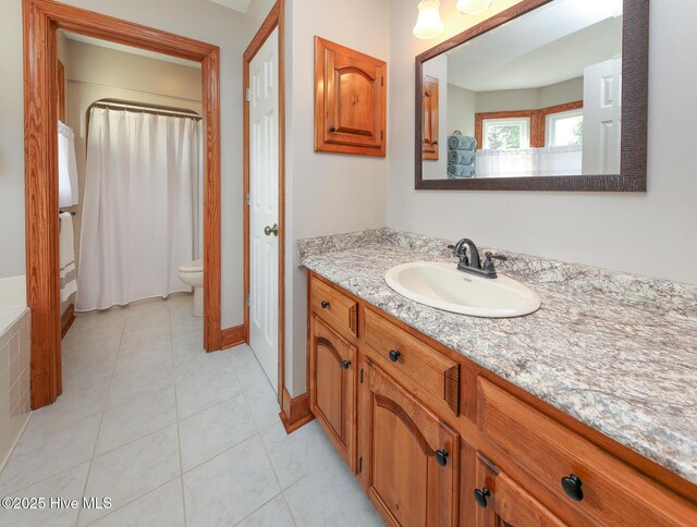 813 Puddin Ridge Rd, Moyock, NC 27958 - bathroom featuring vanity, toilet, baseboards, curtained shower, and tile patterned flooring