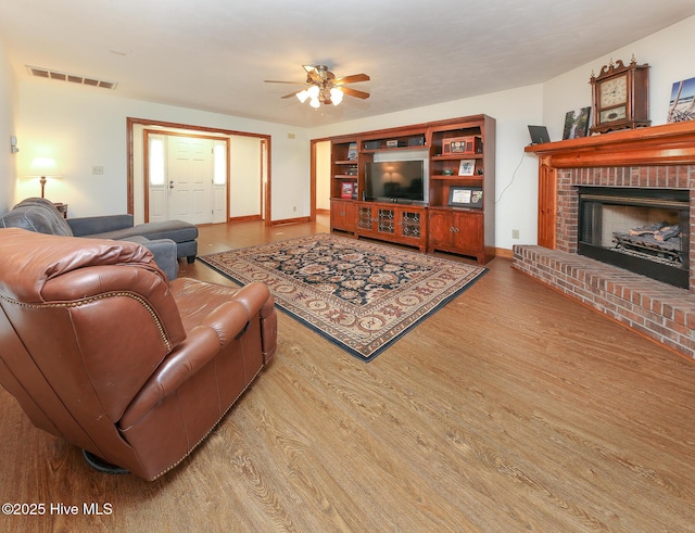 813 Puddin Ridge Rd, Moyock, NC 27958 - living room with a ceiling fan, wood finished floors, a fireplace, and baseboards