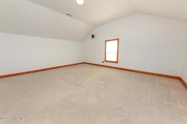 813 Puddin Ridge Rd, Moyock, NC 27958 - additional living space featuring vaulted ceiling, baseboards, and light carpet