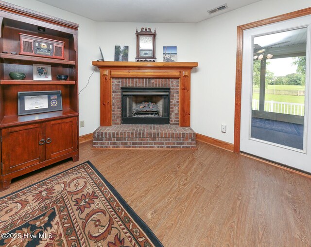813 Puddin Ridge Rd, Moyock, NC 27958 - living room with wood finished floors, baseboards, and a fireplace
