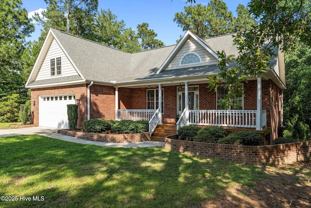 103 Sandspur Ln, West End, NC 27376 - view of front facade featuring a porch, concrete driveway, roof with shingles, and a front yard
