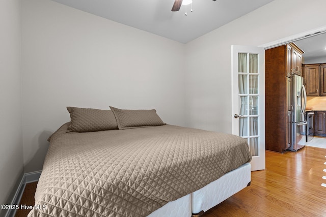 103 Sandspur Ln, West End, NC 27376 - bedroom with stainless steel fridge, light wood-type flooring, ceiling fan, and vaulted ceiling