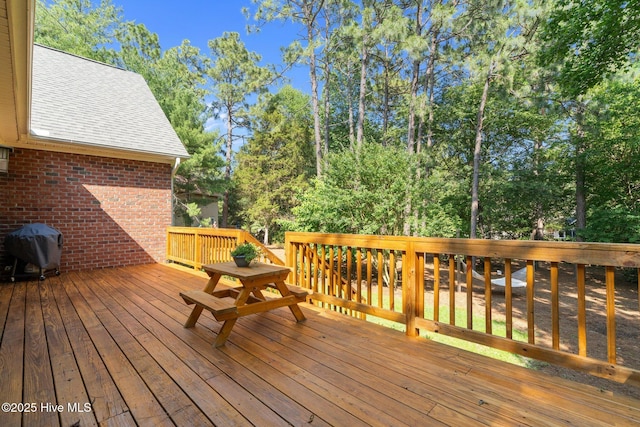 103 Sandspur Ln, West End, NC 27376 - wooden deck with area for grilling and view of scattered trees
