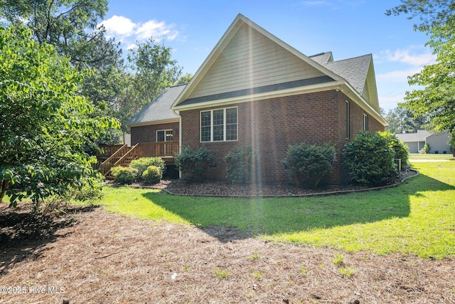 103 Sandspur Ln, West End, NC 27376 - rear view of house featuring brick siding, a yard, stairway, and a shingled roof
