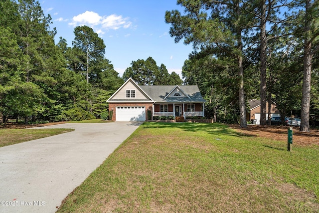103 Sandspur Ln, West End, NC 27376 - view of front of house with a porch, driveway, a front lawn, a garage, and brick siding