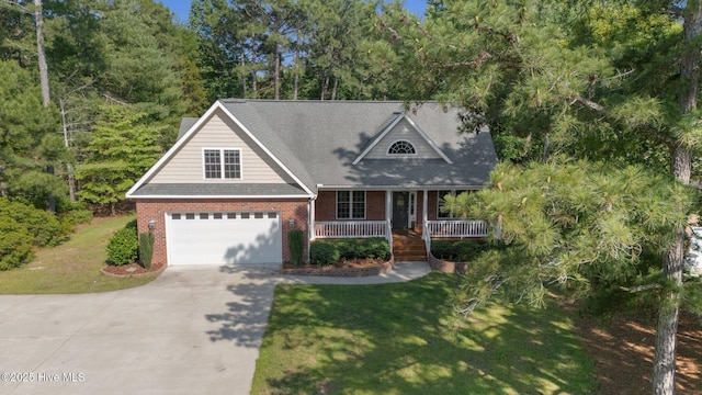 103 Sandspur Ln, West End, NC 27376 - view of front of house with concrete driveway, brick siding, covered porch, and a front yard