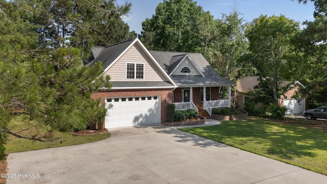 103 Sandspur Ln, West End, NC 27376 - traditional home with a porch, brick siding, driveway, a front lawn, and an attached garage