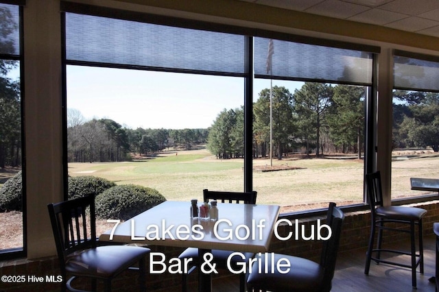 103 Sandspur Ln, West End, NC 27376 - dining area with view of wooded area, plenty of natural light, and wood finished floors