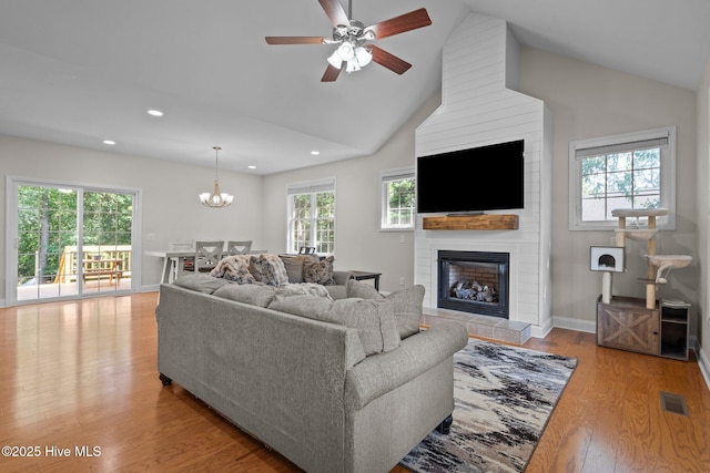 103 Sandspur Ln, West End, NC 27376 - living room with recessed lighting, wood finished floors, a large fireplace, a chandelier, and a ceiling fan