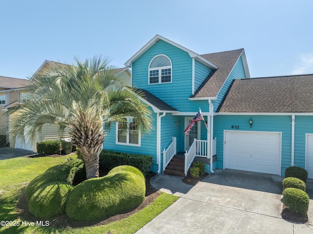 632 Settlers Ln, Kure Beach, NC 28449 - view of front facade with an attached garage, roof with shingles, and concrete driveway