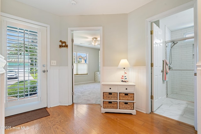 632 Settlers Ln, Kure Beach, NC 28449 - entryway featuring wainscoting, ceiling fan, and light wood-style floors