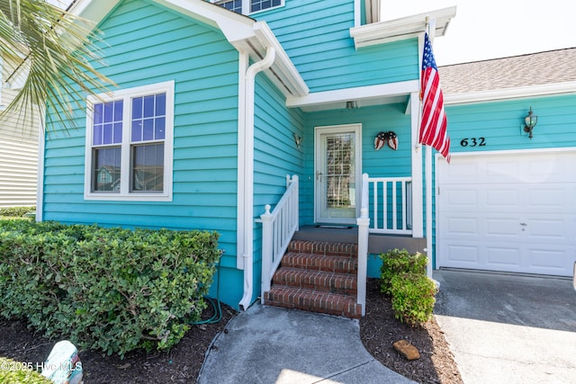 632 Settlers Ln, Kure Beach, NC 28449 - property entrance with an attached garage and driveway
