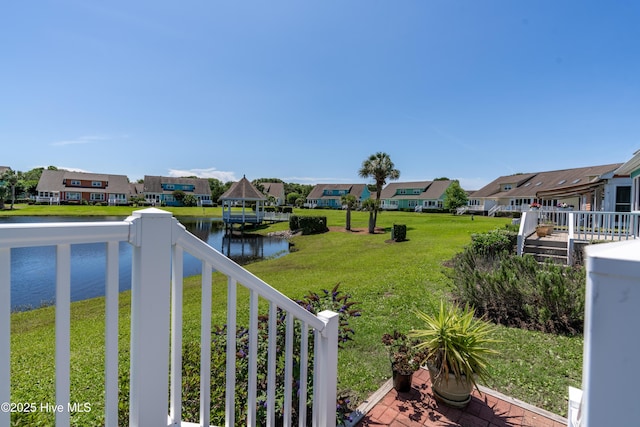 632 Settlers Ln, Kure Beach, NC 28449 - view of green lawn with a residential view, a water view, and a balcony