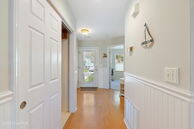 632 Settlers Ln, Kure Beach, NC 28449 - hallway featuring a wainscoted wall and light wood finished floors