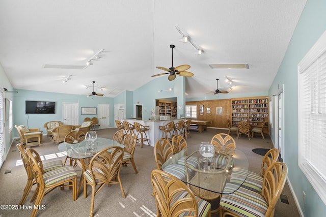 632 Settlers Ln, Kure Beach, NC 28449 - carpeted dining area with rail lighting, ceiling fan, and vaulted ceiling