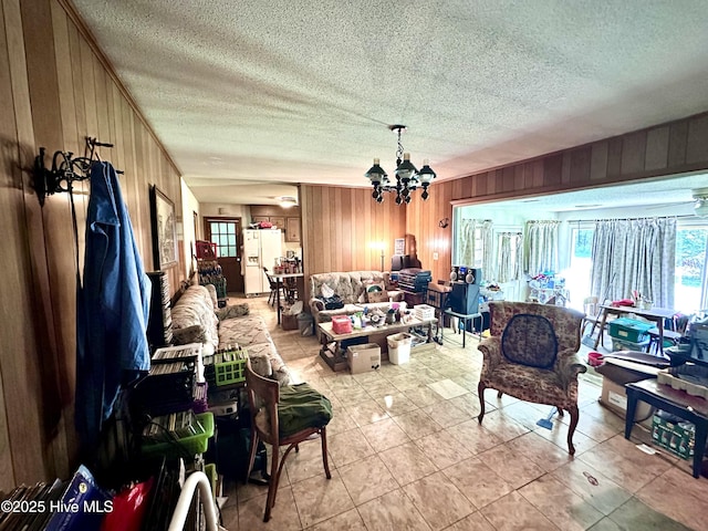 2513 David Ave, Kinston, NC 28501 - living room featuring wood walls, plenty of natural light, a chandelier, a textured ceiling, and light tile patterned floors