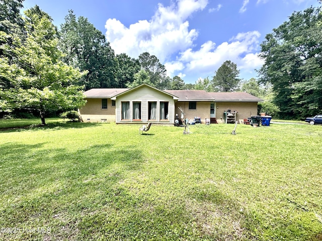 2513 David Ave, Kinston, NC 28501 - rear view of house featuring a lawn