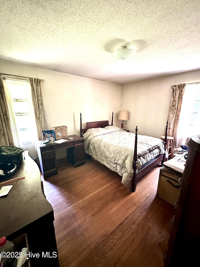 2513 David Ave, Kinston, NC 28501 - bedroom with a textured ceiling and dark wood-style flooring