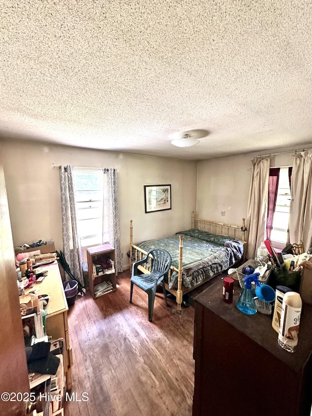 2513 David Ave, Kinston, NC 28501 - bedroom featuring a textured ceiling, multiple windows, and wood finished floors