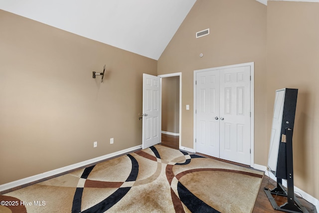 40 Sedgefield Ln, Spring Lake, NC 28390 - bedroom with high vaulted ceiling, baseboards, a closet, and inlaid floor details