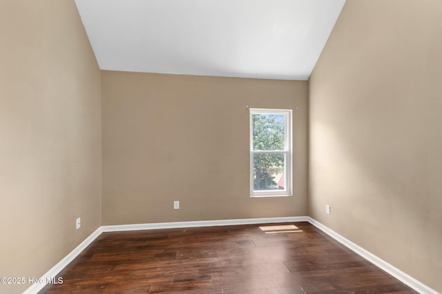 40 Sedgefield Ln, Spring Lake, NC 28390 - empty room featuring lofted ceiling, dark wood-type flooring, and baseboards