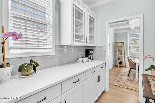 1233 Lt Congleton Rd, Wilmington, NC 28409 - kitchen with ornamental molding, light wood-style floors, white cabinets, glass insert cabinets, and light countertops