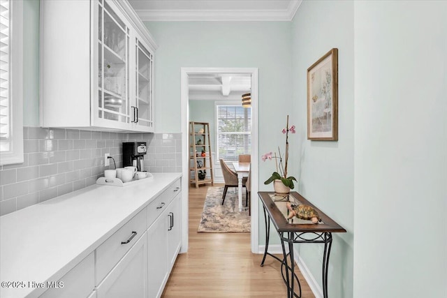 1233 Lt Congleton Rd, Wilmington, NC 28409 - kitchen with light wood-type flooring, light countertops, decorative backsplash, glass insert cabinets, and white cabinets