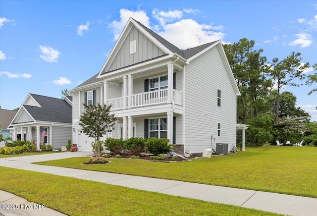 1233 Lt Congleton Rd, Wilmington, NC 28409 - view of front of home featuring board and batten siding, a balcony, cooling unit, and a front yard