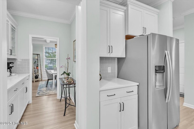 1233 Lt Congleton Rd, Wilmington, NC 28409 - kitchen with stainless steel fridge, ornamental molding, light wood-type flooring, light countertops, and backsplash