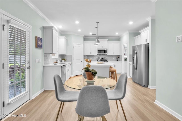 1233 Lt Congleton Rd, Wilmington, NC 28409 - dining room with plenty of natural light, light wood-style floors, baseboards, crown molding, and recessed lighting