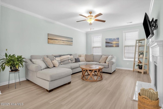 1233 Lt Congleton Rd, Wilmington, NC 28409 - living area featuring light wood-style flooring, ornamental molding, a ceiling fan, baseboards, and a fireplace with flush hearth
