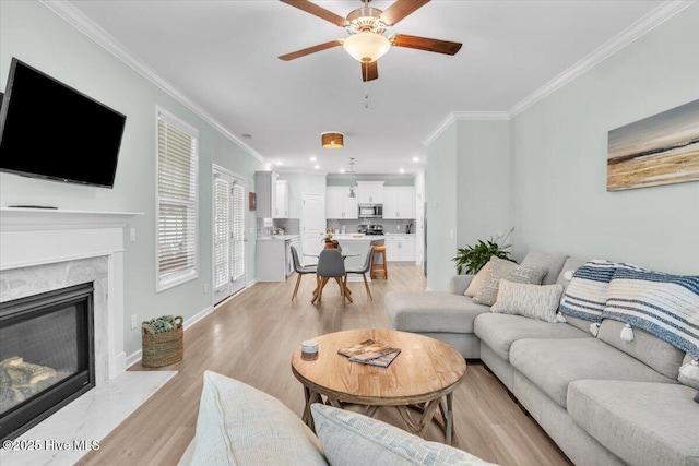 1233 Lt Congleton Rd, Wilmington, NC 28409 - living area with ornamental molding, ceiling fan, light wood finished floors, a fireplace, and baseboards
