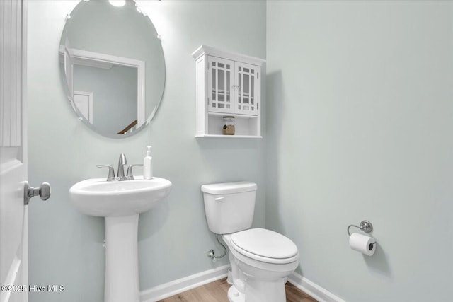 1233 Lt Congleton Rd, Wilmington, NC 28409 - bathroom with wood finished floors, toilet, and baseboards
