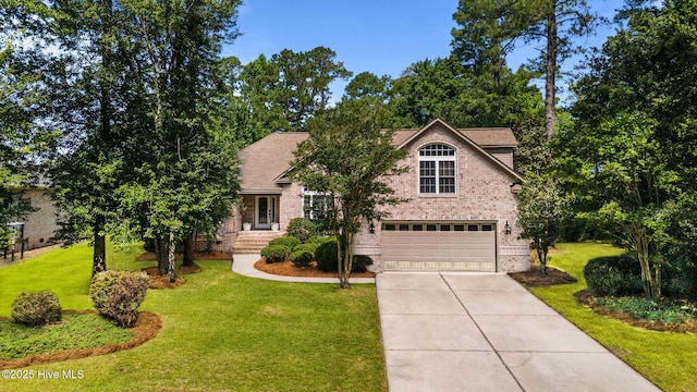 2019 Royal Pines Dr, New Bern, NC 28560 - view of front facade with brick siding, a garage, driveway, and a front lawn